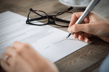 Signing a contract to buy a house in Georgia. The contract is usually signed at what is called a 