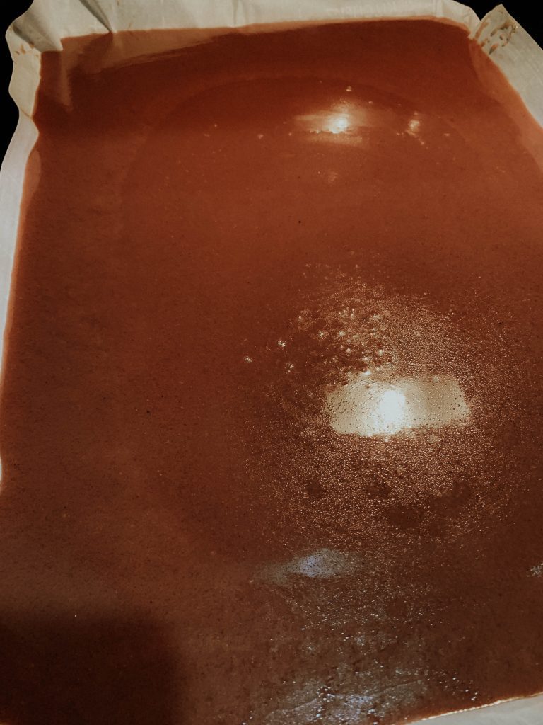 Parchment-lined baking sheet with caramel cooling